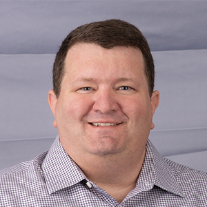 Man wearing plaid shirt headshot